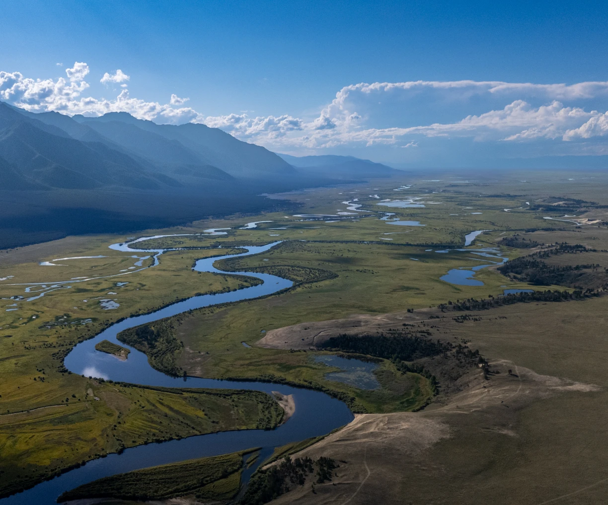 Winding river through expansive landscape